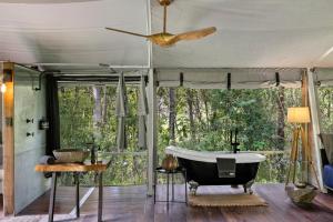 a bath tub in a room with a window at Starry Nights Luxury Camping in Woombye