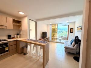 a kitchen with a counter and a table and a couch at Apartamento en Villeta in Villeta