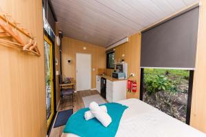 a bedroom with a bed and a large window at Tranquility Ranch by Tiny Away in Wolfdene