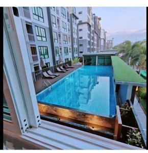 a swimming pool on the balcony of a building at Treasure Condo Kitchenette Wifi in Chiang Mai