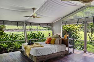 a bedroom with a bed under a tent at Starry Nights Luxury Camping in Woombye