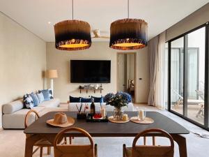 a living room with a table and two chairs at Villa Tierra Pattaya in North Pattaya