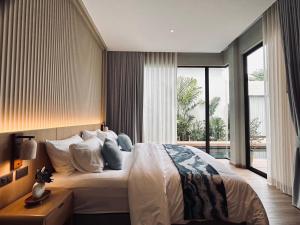 a bedroom with a large bed and a large window at Villa Tierra Pattaya in North Pattaya +52 photos