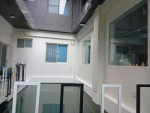 a hallway of a building with a glass floor at 宜蘭縣三星鄉遇雨魚民宿2932 in Gongzhao
