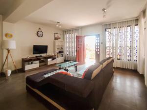a living room with a couch and a tv at Casa Arena & Sol in Santa Rosa