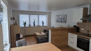 a kitchen with a counter and a table and a window at Ankerplatz35 in Wittmund