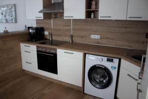 a kitchen with a washer and a washing machine at Ankerplatz35 in Wittmund +11 photos