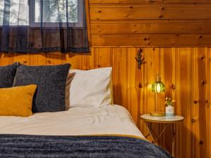 a bedroom with a bed and a table with a lamp at Ravens Retreat in Index +62 photos