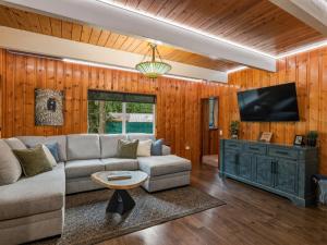 a living room with a couch and a tv at Ravens Retreat in Index