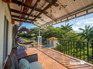 a balcony with a view of a pool at Casa Estrella, Relaxation Begins in Sosúa
