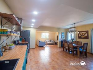 a kitchen and living room with a table and chairs at Casa Estrella, Relaxation Begins in Sosúa