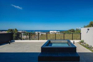 a swimming pool on a patio with a view of the ocean at Luxury Villa Maeda Unit2 in Onna