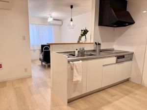 a kitchen with a sink and a stove at ura BETTEi 別邸 in Okayama +26 photos