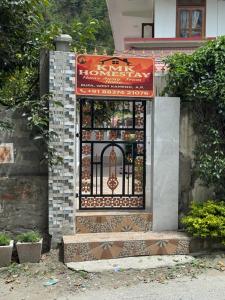 an entrance to a building with a gate at KmK Homestay in Rupa