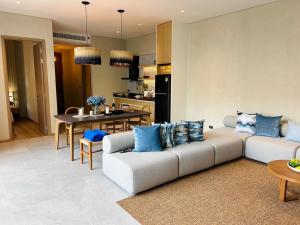 a living room with a couch and a table at Villa Tierra Pattaya in North Pattaya
