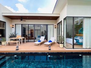 a villa with a swimming pool and a bedroom at Villa Tierra Pattaya in North Pattaya