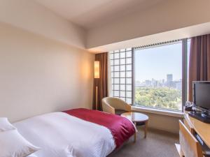 a hotel room with a bed and a window at Hotel Grand Arc Hanzomon in Tokyo