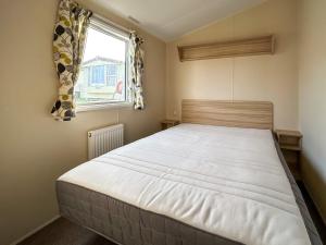 a bedroom with a large bed with a window at The Rochester - Uk51003 in Eastchurch