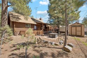 a log cabin with a fire pit in the yard at Forest Hideaway Near Sedona in Munds Park
