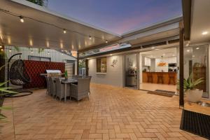 a patio with a table and chairs in a building at Pet Friendly Beachside Hideaway - Lazy on Lowry in Woorim