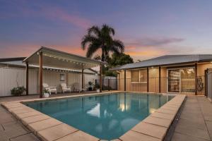 a swimming pool in the backyard of a house at Pet Friendly Beachside Hideaway - Lazy on Lowry in Woorim