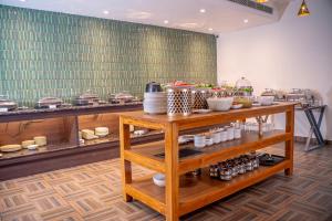 a kitchen with a table with food on it at Mosaic Connect Ayodhya in Ayodhya