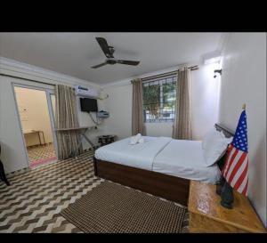 a bedroom with a bed and an american flag at Sanoraaa Resort in Dabolim