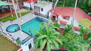 an overhead view of a swimming pool next to a house at Sanoraaa Resort in Dabolim