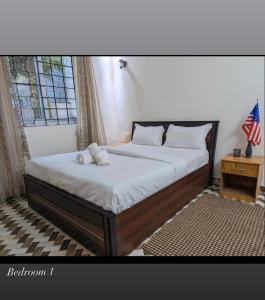 a bedroom with a bed with two white towels on it at Sanoraaa Resort in Dabolim