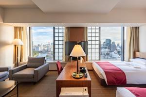 a hotel room with a bed and a large window at Hotel Grand Arc Hanzomon in Tokyo
