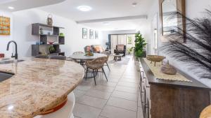 a kitchen and living room with a large counter top at Waterline Direct Poolside Apartment in Agnes Water