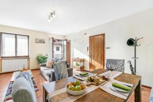 a living room with a table and a couch at Sunset in Baveno: 1 Bed with Balcony - Happy Rentals in Baveno