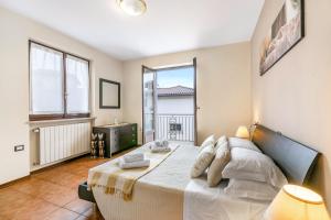 a bedroom with a bed and a large window at Sunset in Baveno: 1 Bed with Balcony - Happy Rentals in Baveno