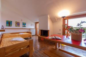 a living room with two beds and a fireplace at Sunset in Ranco: Lakeview Townhouse with Private Garden - Happy Rentals in Ranco