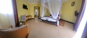 a living room with two beds and a couch at Philo Leisure Gardens in Kalangala