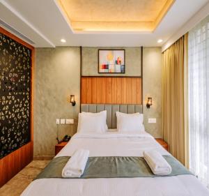 a bedroom with a large bed with white sheets at Hotel Morya Suites IGI Airport in New Delhi +19 photos
