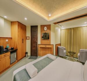 a bedroom with a large white bed in a room at Hotel Morya Suites IGI Airport in New Delhi