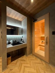 a kitchen with a sink and a wooden floor at 宿andFanハマハマ in Meinohama +26 photos
