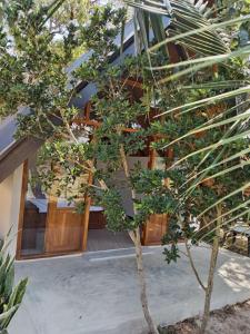 a house with a tree in front of it at Sunset Dream Cabana in Tangalle