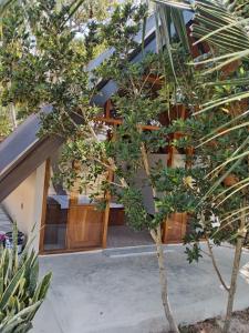 a house with a tree in front of it at Sunset Dream Cabana in Tangalle +12 photos