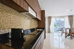 a kitchen with a sink and a counter top at Aqua Maya Phuket in Patong Beach