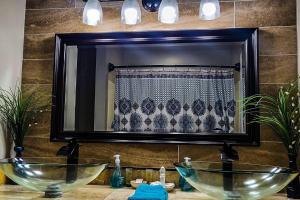 a bathroom with two sinks in front of a mirror at Seaside Gem in Biloxi