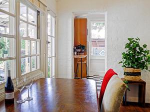 a dining room with a table and a bottle of wine at The old Chiltern bank BnB in Chiltern