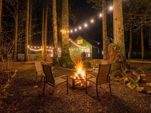 two chairs and a fire pit in a yard at night at Ravens Retreat in Index