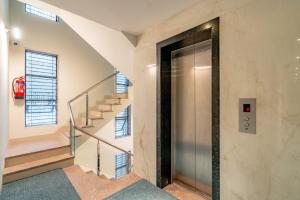 an elevator in a building with a staircase at Playsales SSR in Indore