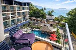 a balcony with chairs and a view of the ocean at Aqua Maya Phuket in Patong Beach
