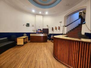 a lobby with a staircase and a waiting room at Hotel Raunak in Kolkata