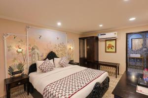 a bedroom with a large bed in a room at Ved Mahal in Jaipur