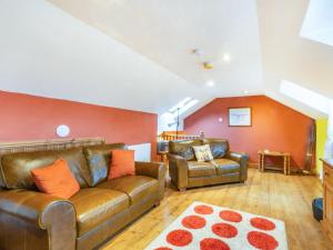 a living room with a couch and a chair at Smugglers View Nr Whitby in Ravenscar +20 photos