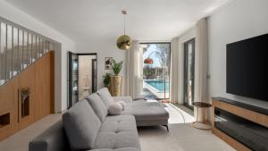 a living room with a couch and a tv at Vila Laguna Blu by Villas Guide in Trget